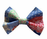 Handmade dog bow tie in a pretty patchwork print in shades of pale blue, pink amd green. Handmade in the UK and washable