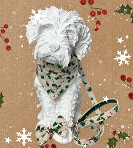 Dog mannequin wearing the Christmas Holly Berry dog bandana made from a natural cotton printed with holly leaves and berries. Handmade and washable.