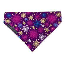 Christmas Snowflakes dog bandana made from a purple cotton printed with gold, purple and turquoise snowflakes. Handmade and washable.