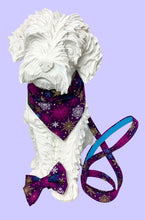 Dog mannequin wearing the Christmas Snowflakes dog bandana made from a purple cotton printed with gold, purple and turquoise snowflakes. Handmade and washable.