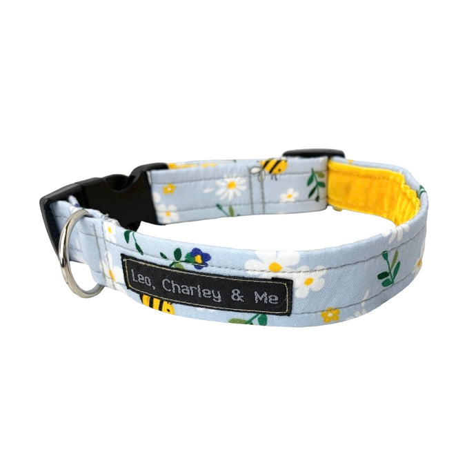 Fresh baby blue dog collar printed with flowers and bees. Perfect for Spring. Has a yellow velvet lining. Handmade in the UK and washable.