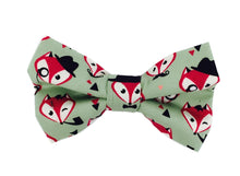 Handmade dog bow tie in cotton print. Made by hand in the U.K. and washable. Sage green with foxy faces printed on. 