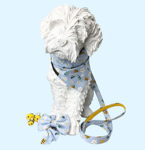 Dog mannequin wearing a pale blue bee and daisy print collar, lead, bandana and bow tie.  Hand made in the UK and washable.