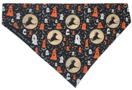 Halloween dog bandana in black cotton poplin with witches and ghosts printed in white and orange. Handmade and washable