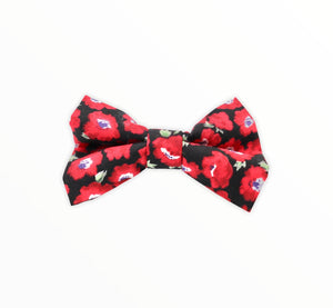 Handmade dog bow tie in cotton print. Made by hand in the U.K. and washable. Red Poppy print on black cotton poplin.