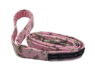 Pink bee print dog lead with strong internal webbing, metal trigger hook and integral D ring.  The handle is lined with pink velvet. Handmade and washable. 