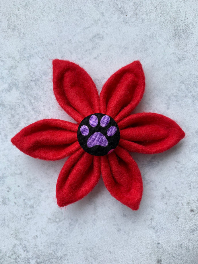 Handmade felt dog collar flower in bright red with a paw print central button. Made in the UK 