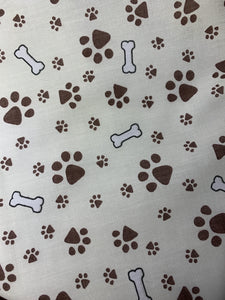 Paw and Bone print fitted fabric facemasks. Cream with brown paw prints. Washable and reusable.  Made in the U.K. 