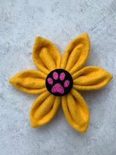 Handmade dog collar flower in vibrant yellow felt with a paw print central button. Made in the UK