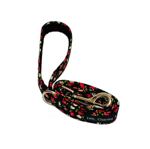 Handmade black fabric dog lead with a pretty pink floral print. It has a metal alloy trigger hook and a D ring with a velvet ribbon lined handle.  Handmade in the U.K. and washable.