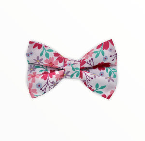 Handmade dog bow tie in cotton print. Made by hand in the U.K. and washable. Floral print in shades of pink and lilac. 
