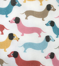 Multicoloured sausage dog print fitted face mask on a white background. Washable and reusable, made in the U.K. 