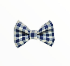 Handmade dog bow tie in cotton print. Made by hand in the U.K. and washable. Navy and cream checked cotton bow. 