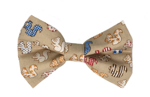 Handmade dog bow tie in cotton print. Made by hand in the U.K. and washable. Sandy coloured cotton poplin printed with squirrels. 