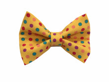 Handmade dog bow tie in cotton print. Made by hand in the U.K. and washable. Sunshine yellow cotton poplin with multicoloured spots. 