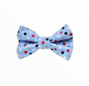 Handmade dog bow tie in cotton print. Made by hand in the U.K. and washable. Pale blue with polka dots in red blue and white