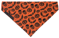 Orange Halloween dog bandana with bats, pumpkins and bats on it. Handmade in the U.K. and washable. 