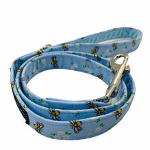 Hand madedog lead in blue cotton bee and floral print. Zinc alloy trigger hook and velvet lined handle. Hand made in the UK and washable.