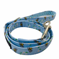 Hand madedog lead in blue cotton bee and floral print. Zinc alloy trigger hook and velvet lined handle. Hand made in the UK and washable.