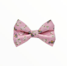 Handmade dog bow tie in cotton print. Made by hand in the U.K. and washable. Pale pink with tiny bees and flowers printed on it. 