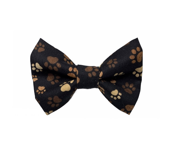 Handmade dog bow tie in cute cotton poplin muddy paw print. Washable and made in the UK. Matching items available